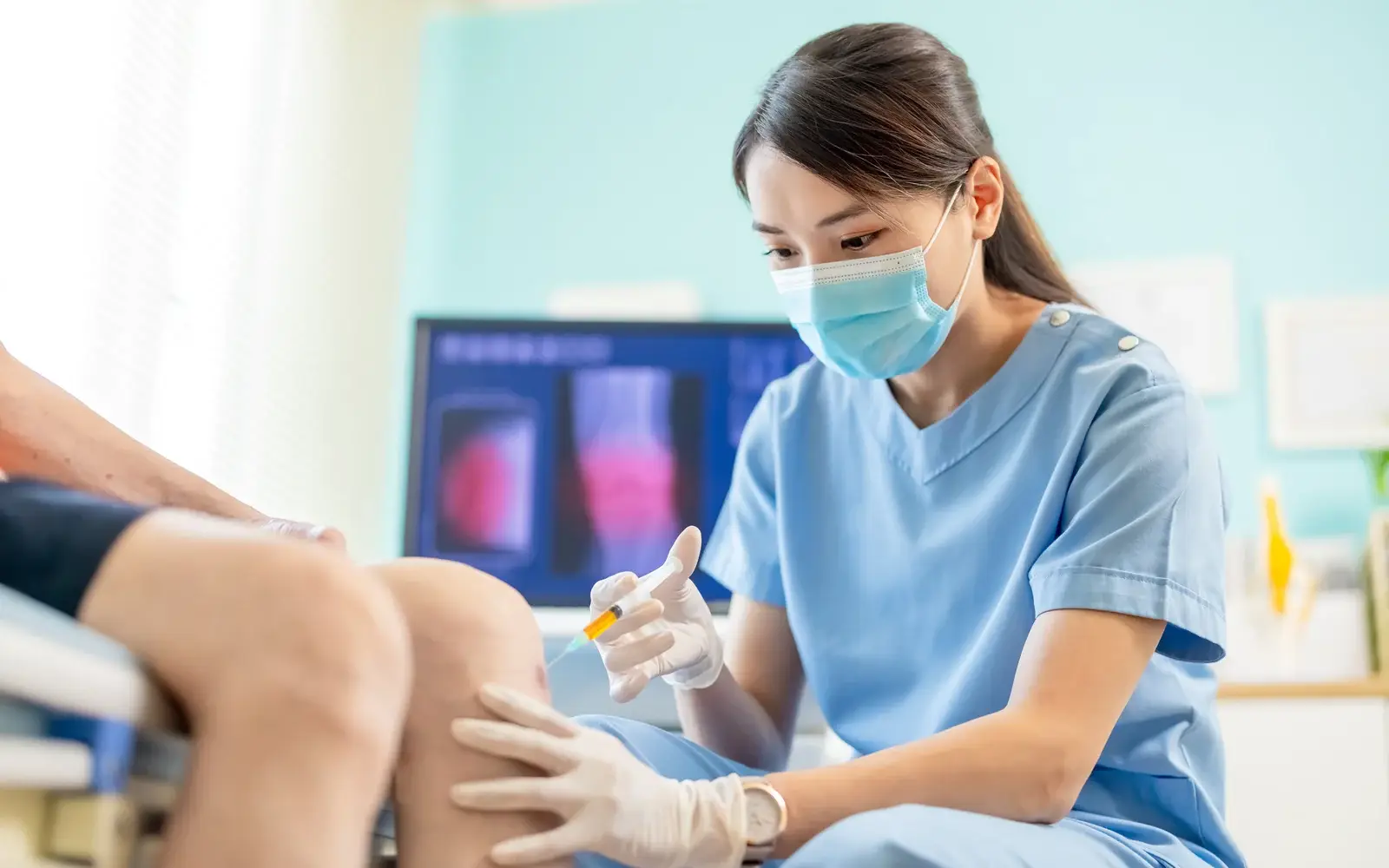 A physician performing a platelet-rich plasma injection at a South Tempe, AZ clinic