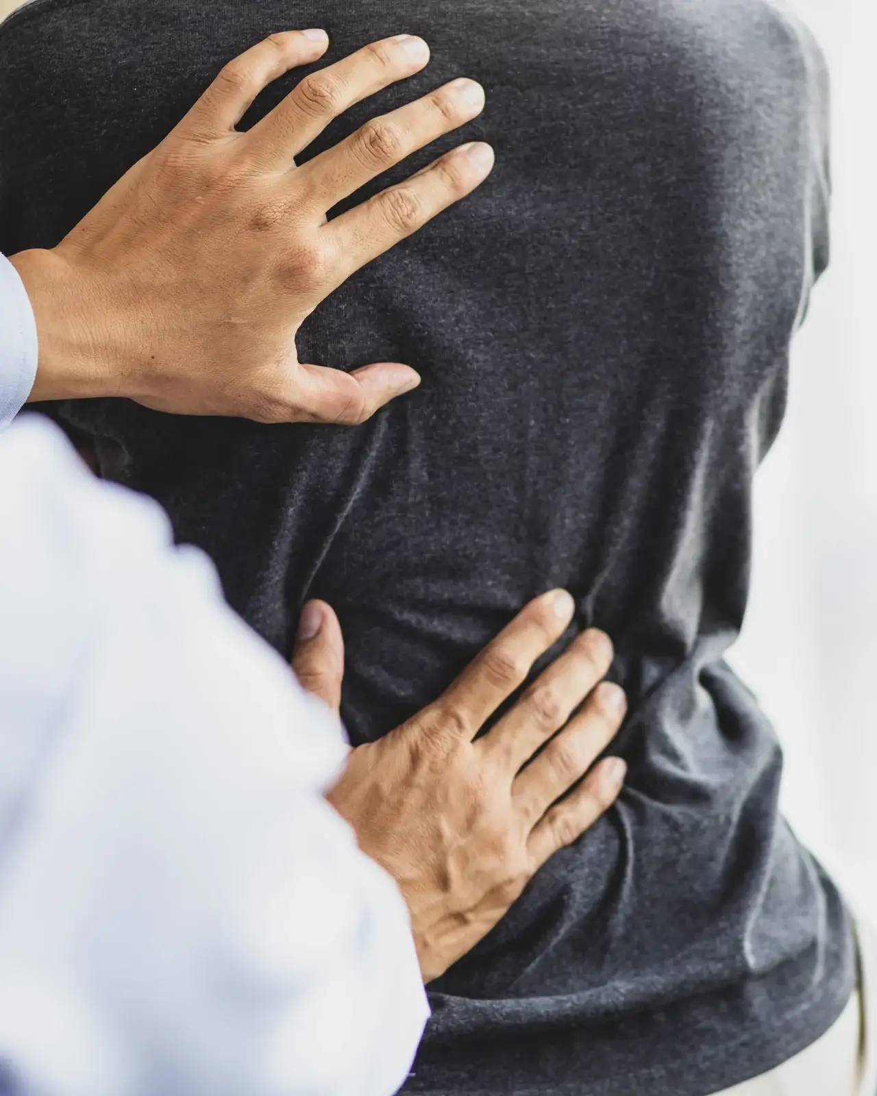 A naturopathic physician assessing a patient area of pain in South Tempe, AZ