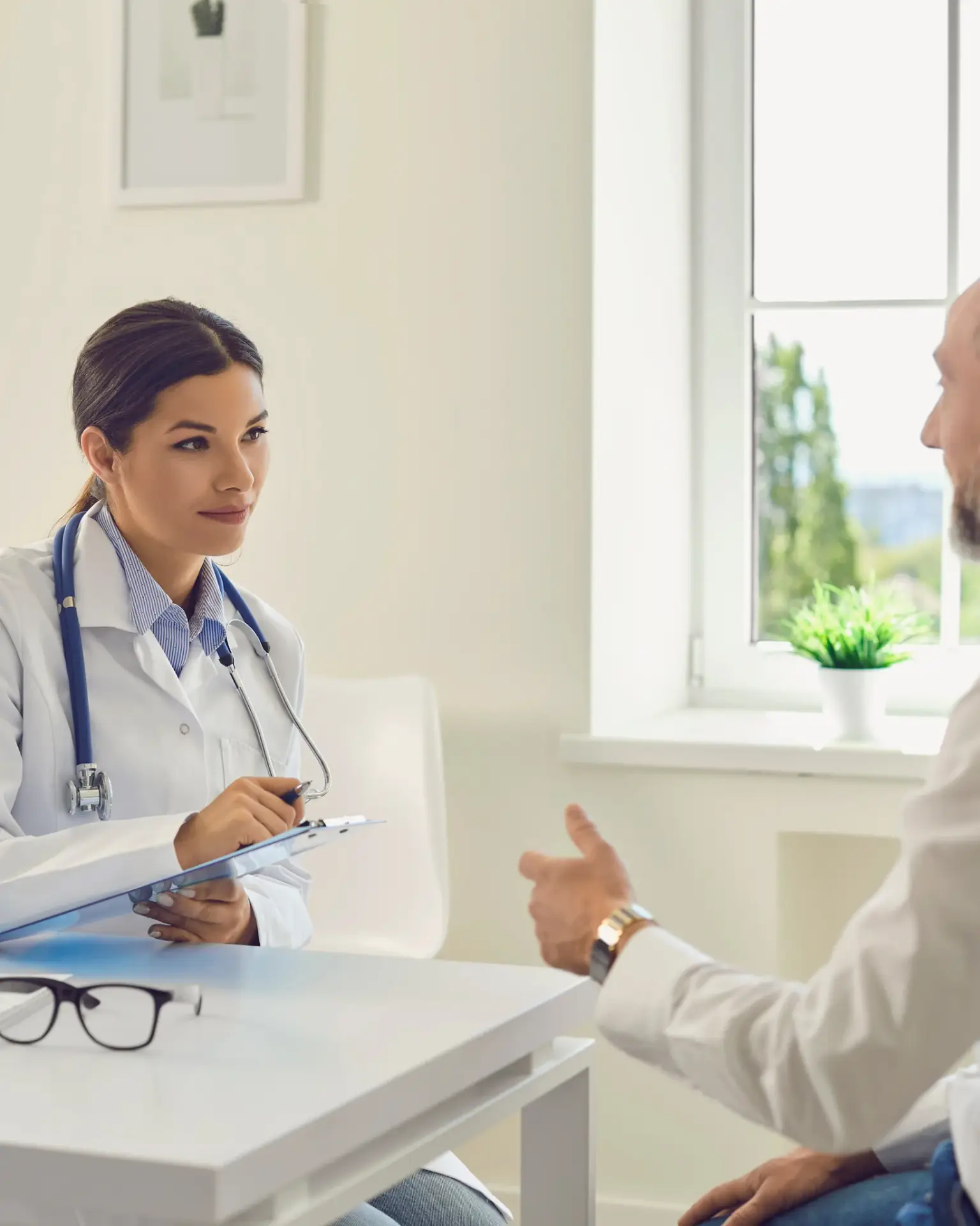 A naturopathic physician reviewing lab results with a male patient during an erectile dysfunction consultation in South Tempe, AZ
