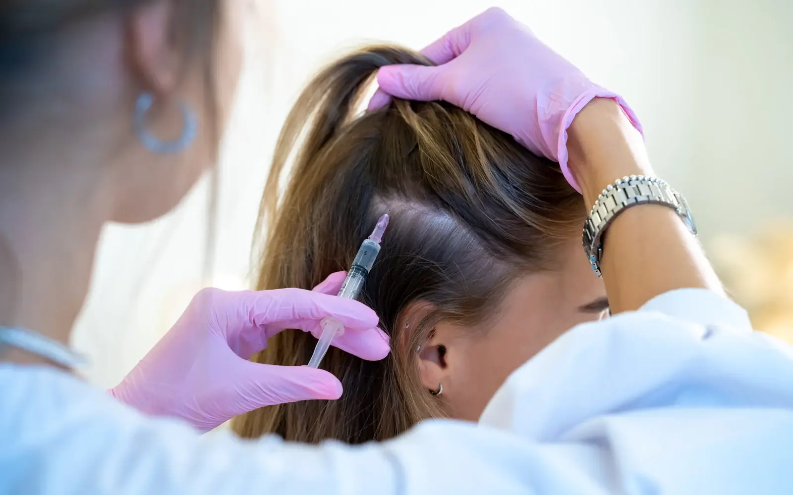 A clinician performing a platelet-rich plasma scalp treatment for hair loss in South Tempe, AZ
