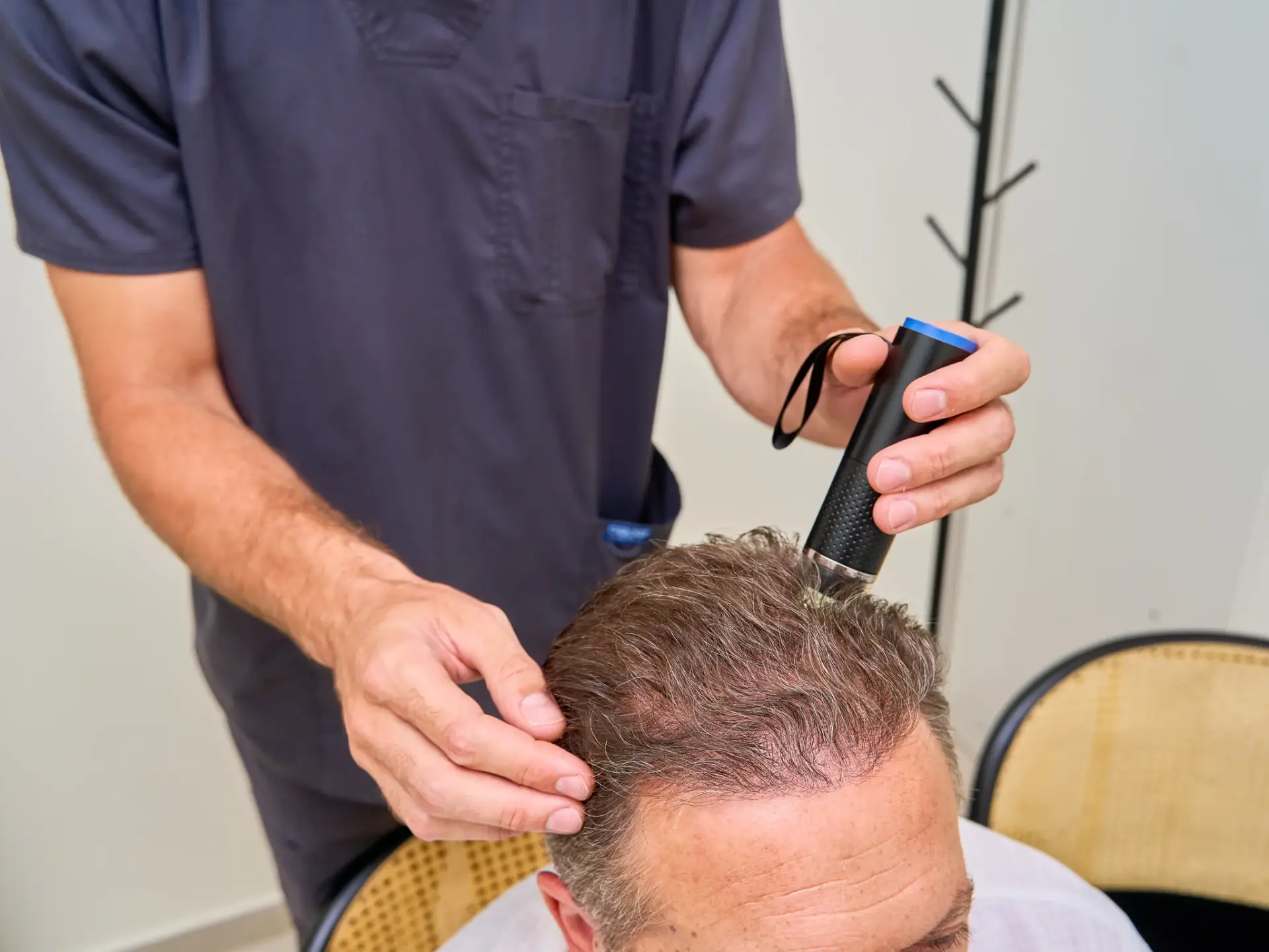 A naturopathic physician assessing a patient scalp and hair density in South Tempe, AZ