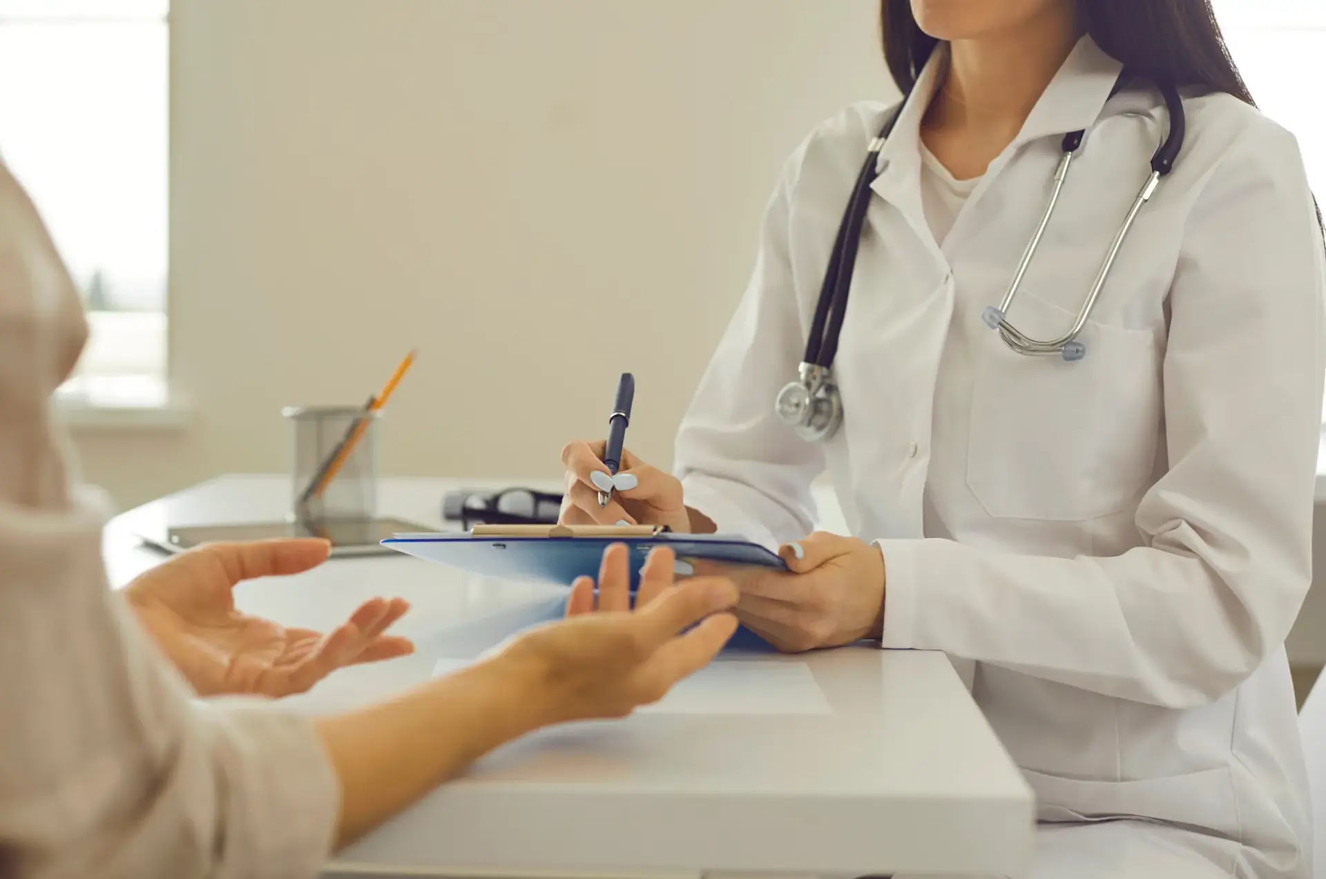 A naturopathic physician discussing hormone symptoms with a female patient in South Tempe, AZ