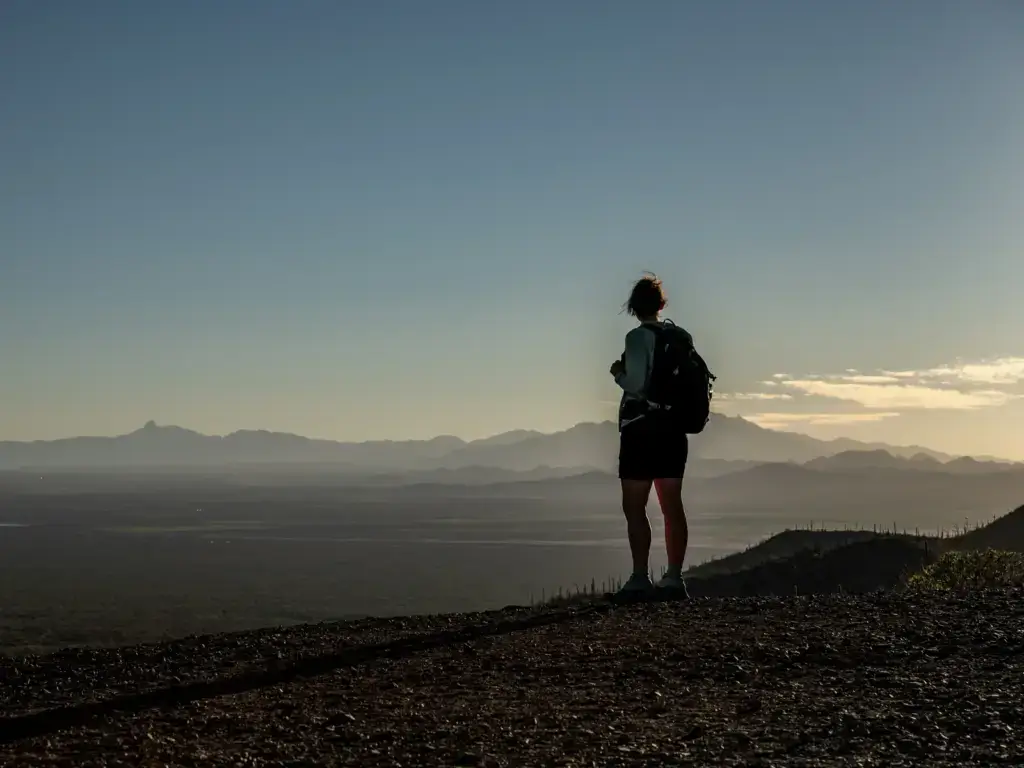 Hiker on a Sonoran Desert ridge in Arizona, where year-round sun affects skin aging