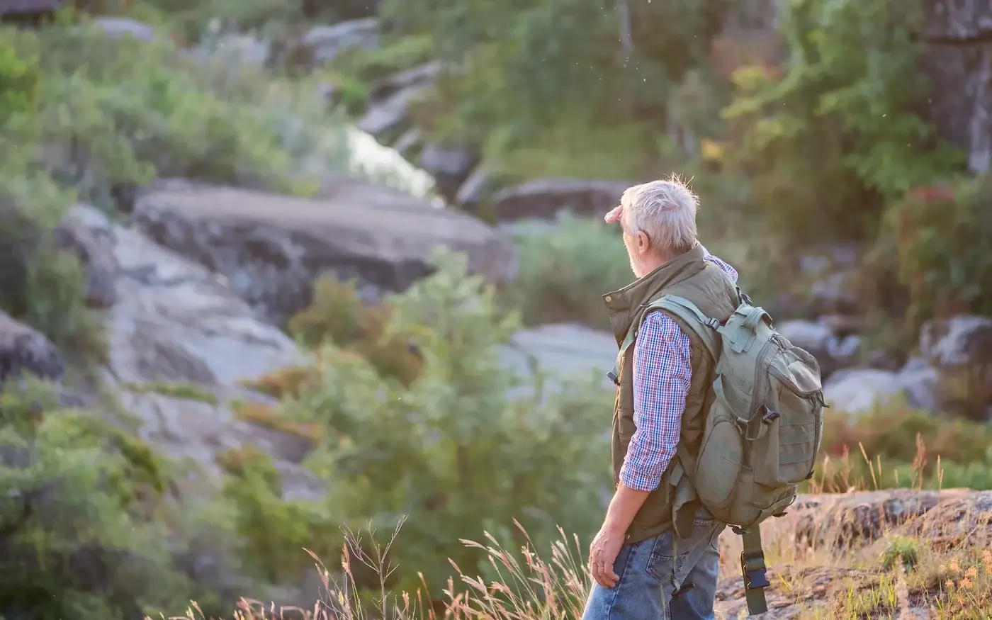 Active mature man hiking a rocky trail, men's hormone optimization in South Tempe, AZ