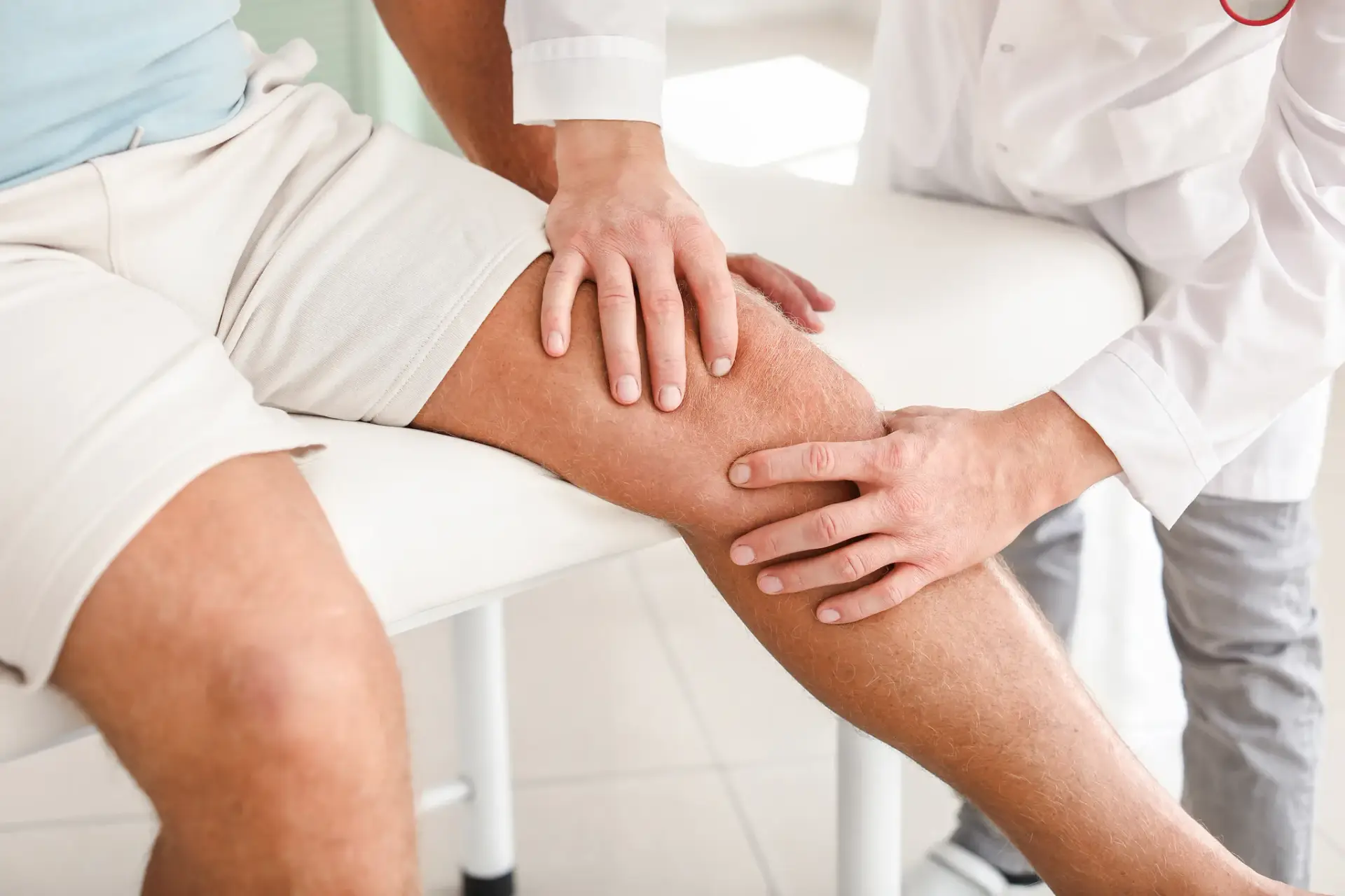 A naturopathic physician assessing a patient in pain at a South Tempe, AZ clinic