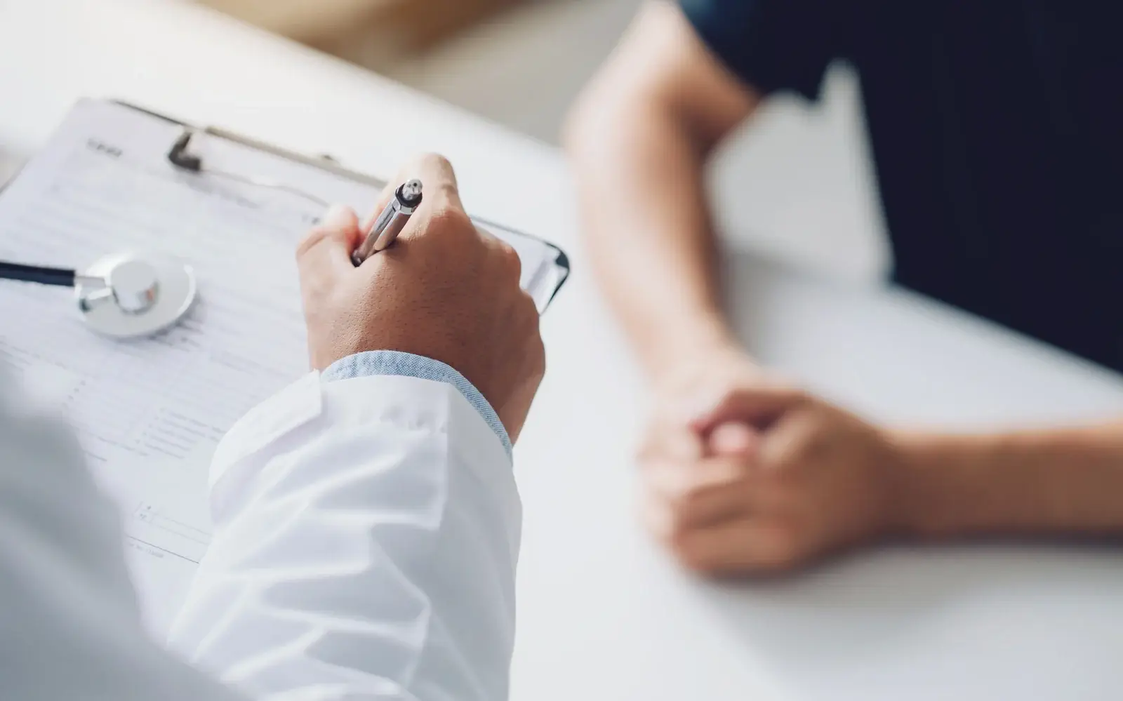 A naturopathic physician reviewing a patient intake before PEMF therapy in South Tempe, AZ