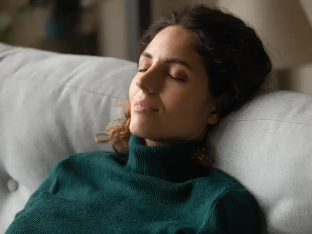 A person resting quietly at home between PEMF therapy sessions in South Tempe, AZ