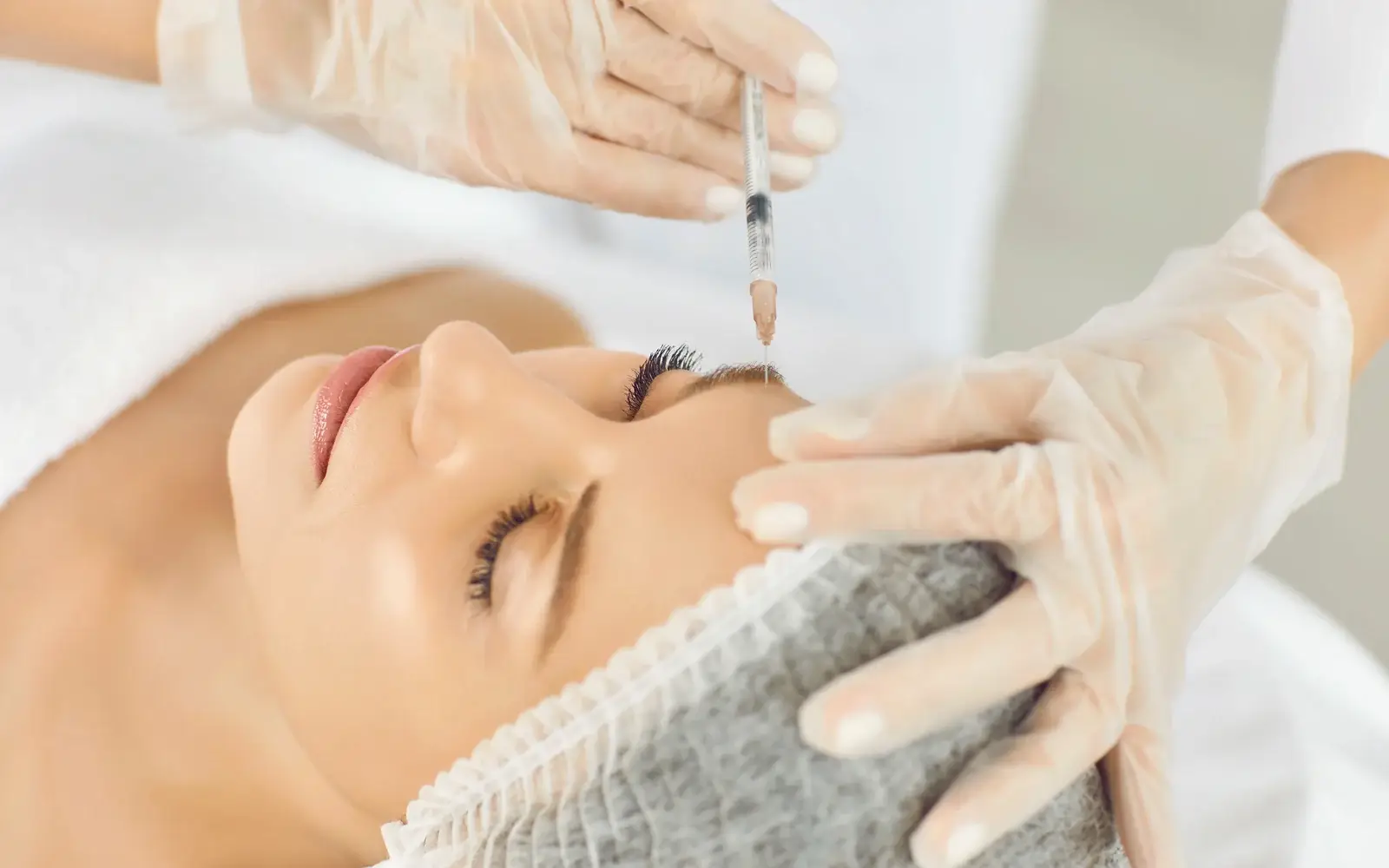 A clinician placing a fine injection around the eye area during a PRP treatment in South Tempe, AZ