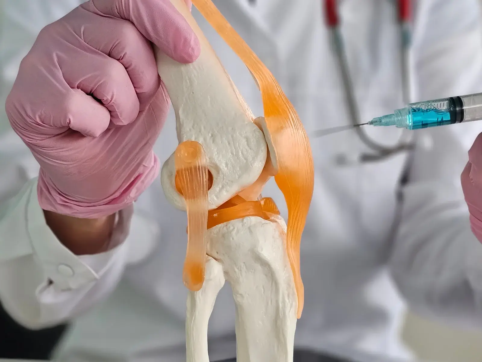 A physician examining a patient joint before regenerative injection therapy in South Tempe, AZ